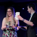 stage magician with suprised audience member