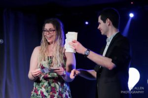stage magician with suprised audience member