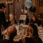close up magician performing at a table for a Christmas party