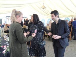 close up magician performing at a party