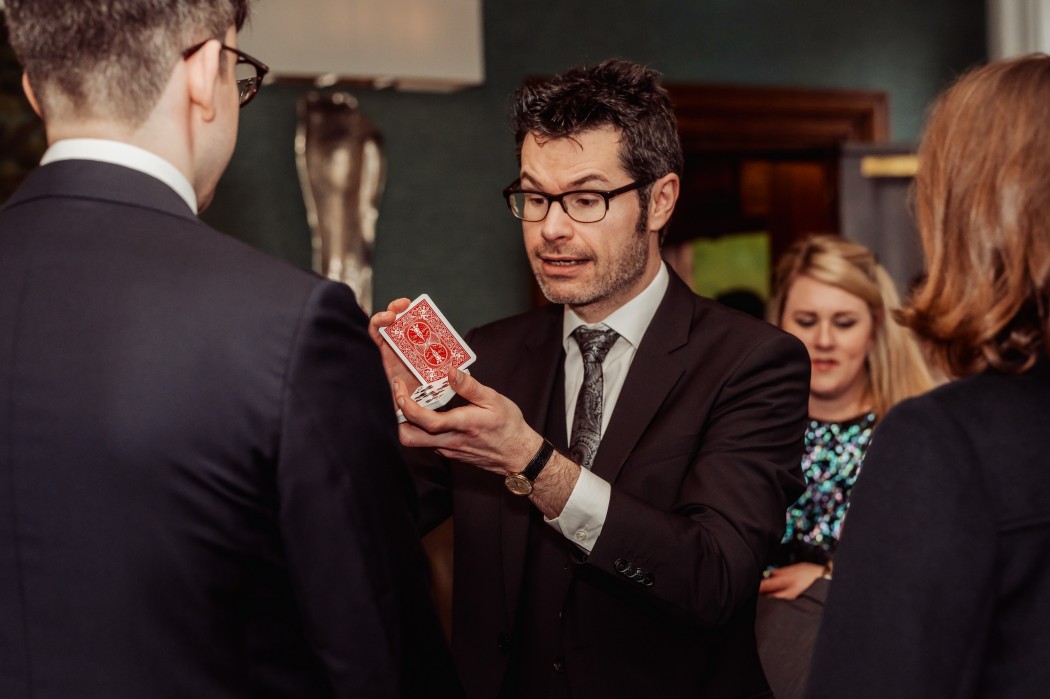 close up magician performing at a christas party