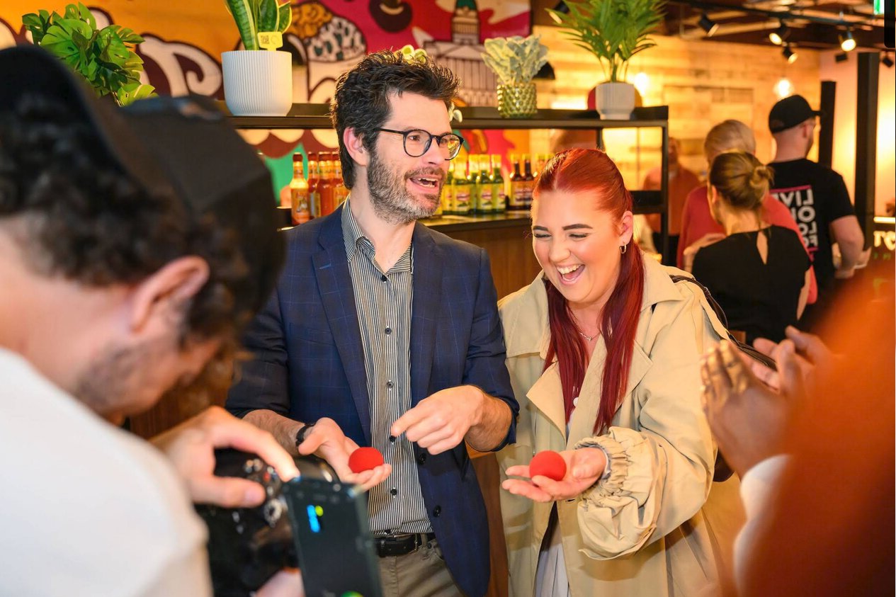 woman laughing at close up magician available to hire