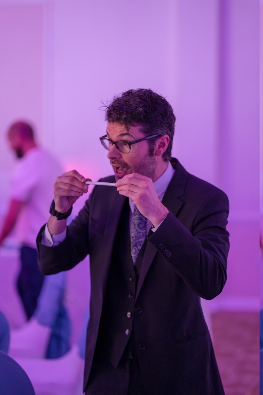 close up magician performing a sleight of hand magic trick at an event in sheffield