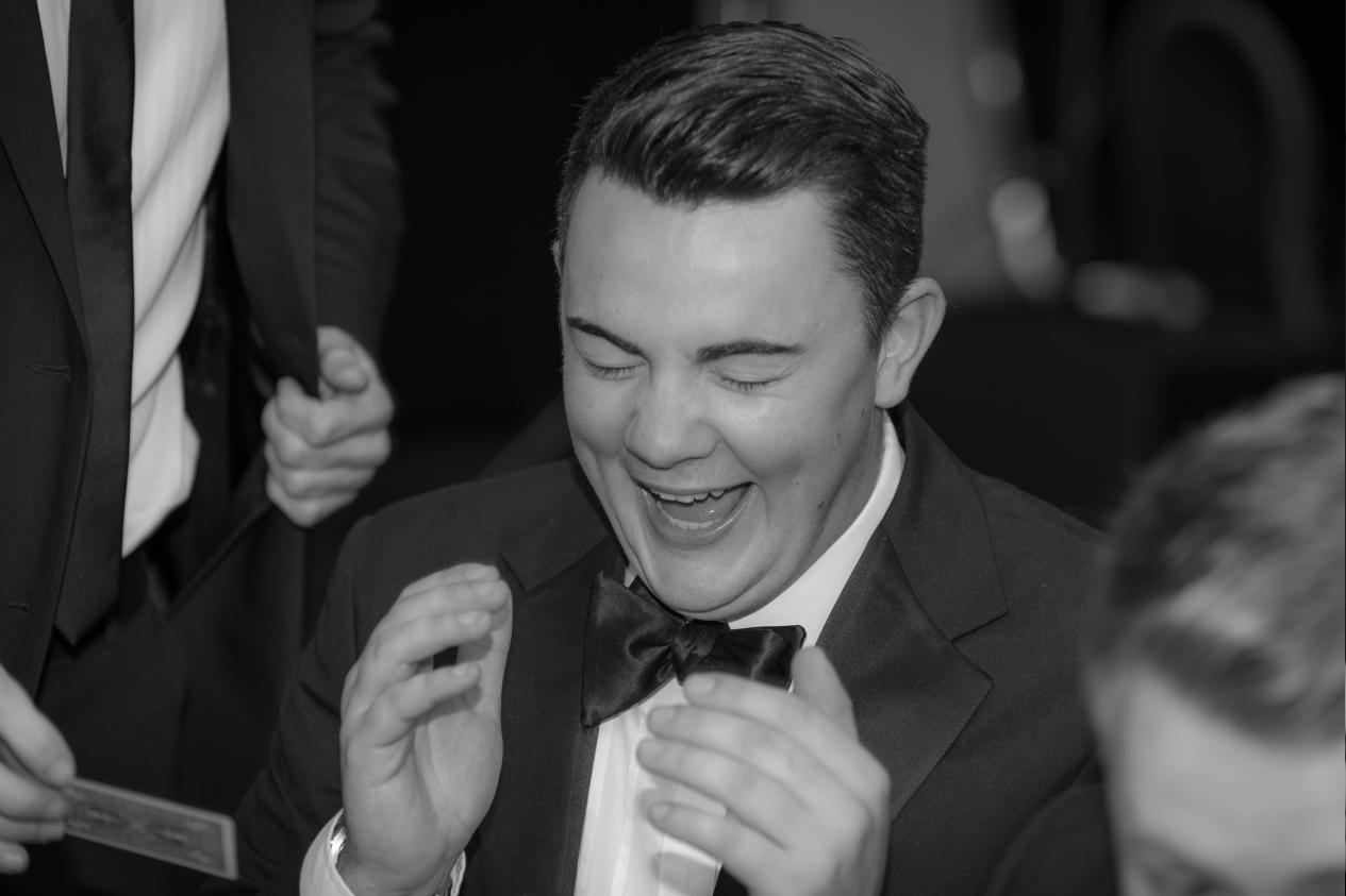 guess at a black tie ball in london laughing and applauding magic