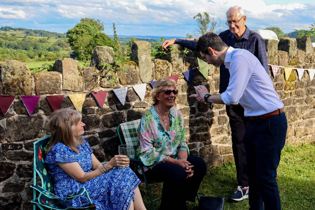 close up magician performing outdoors at a summer event