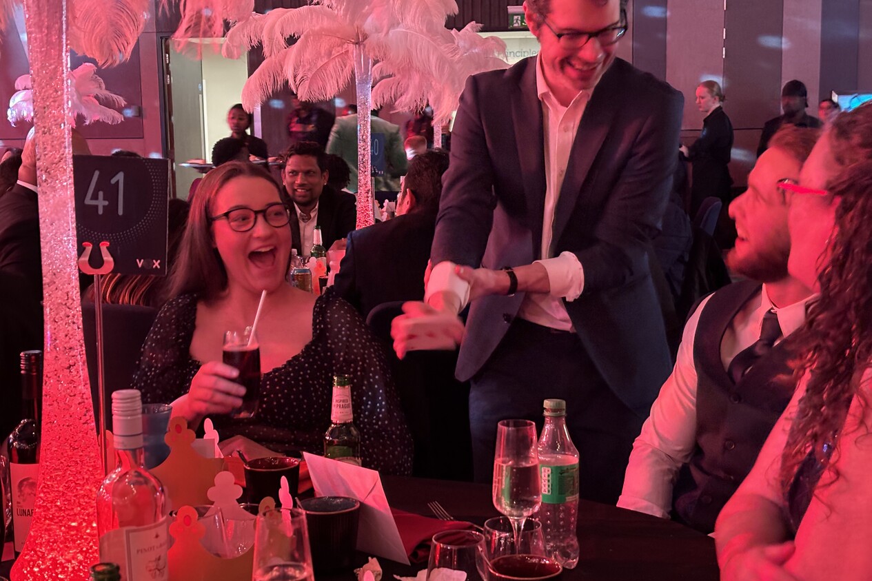 students at a university event laughing with close up magician