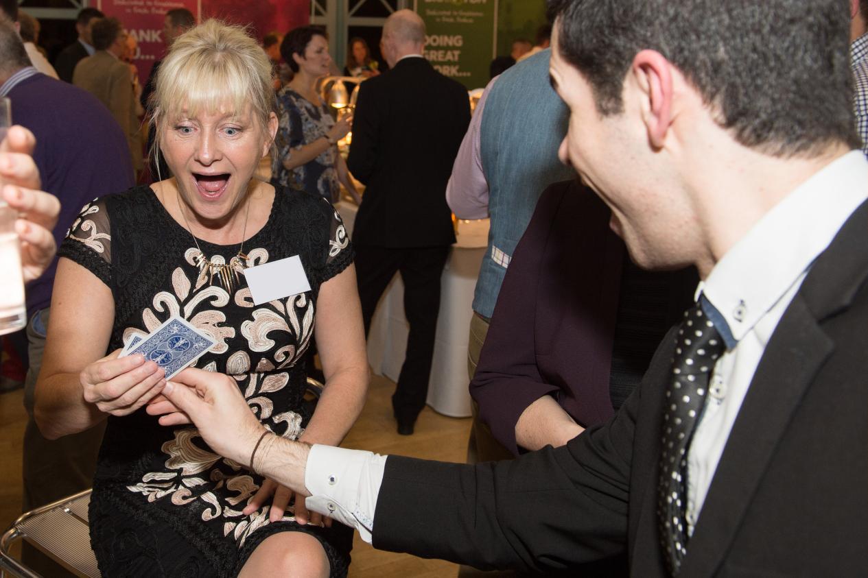 walkaround close up magician amazing guests at a corporate event in Manchester