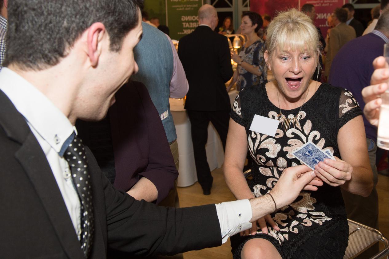 woman at corporate networking event responding to incredible close up magic