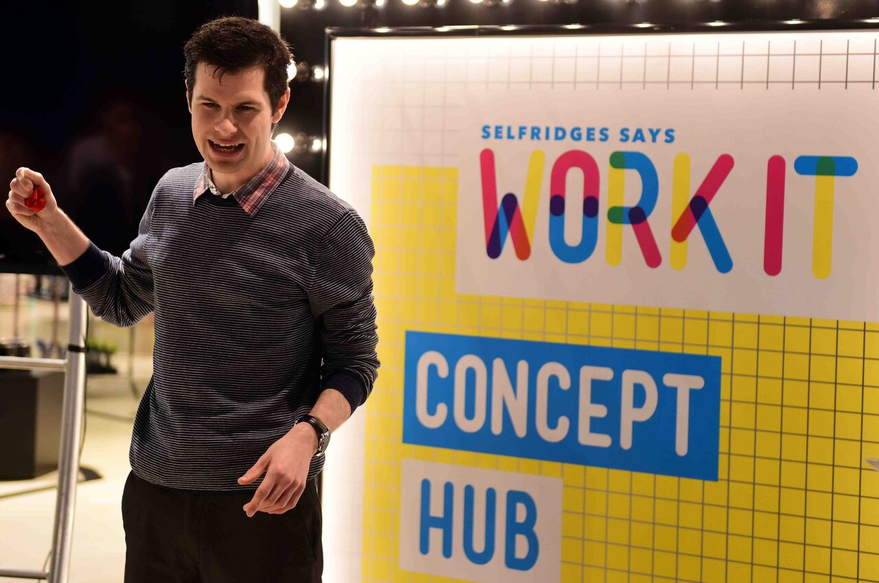 magician in front of a marketing banner at a london trade show