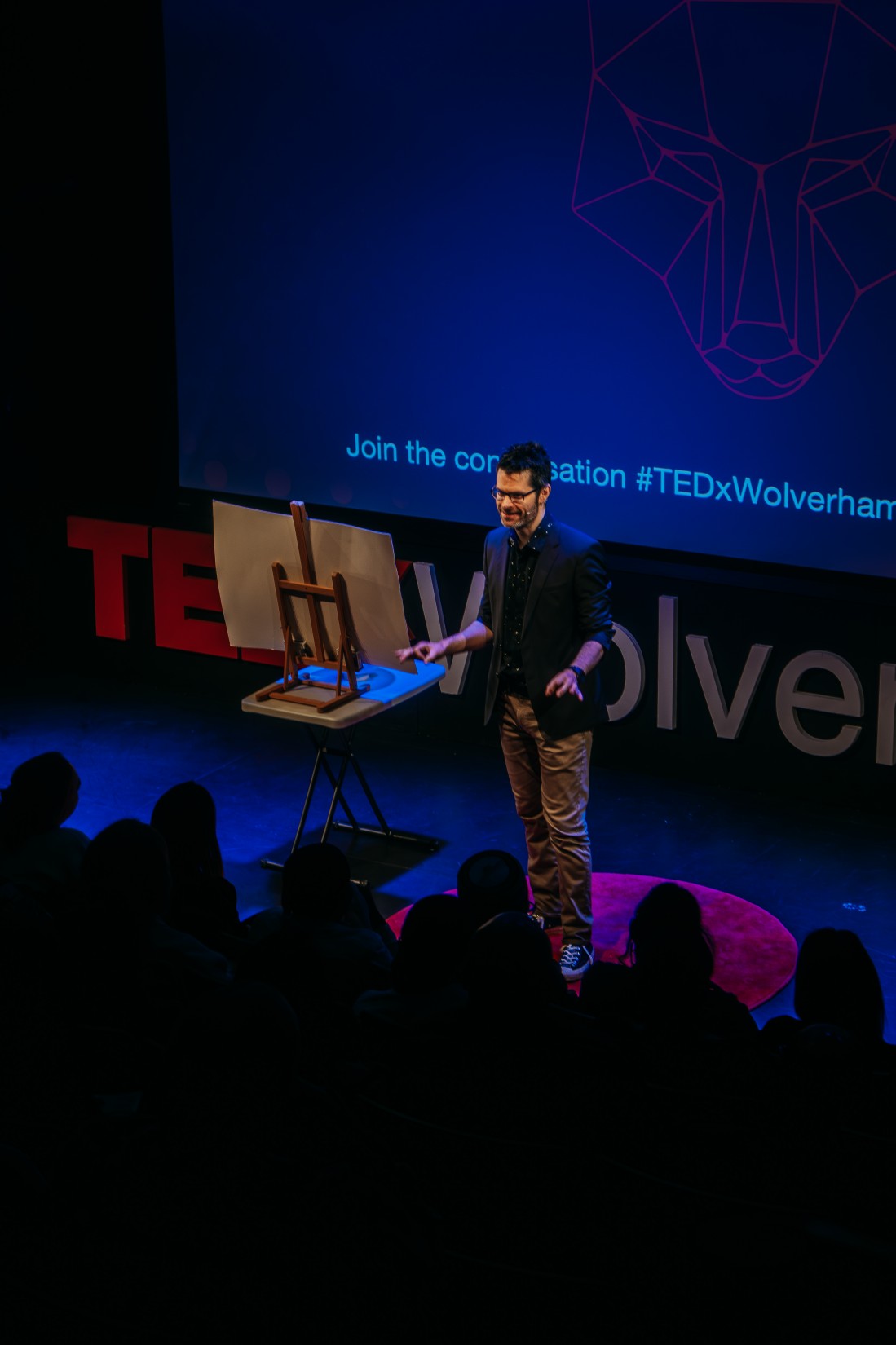 london magician ed sumner on stage at a tedx conference