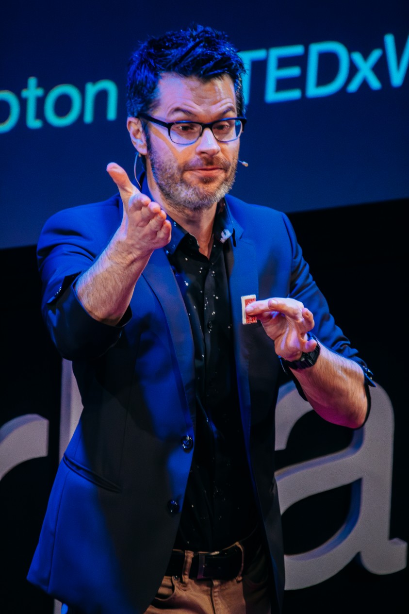 corporate magician and enterainer ed sumner on stage with a corporate mind reading show