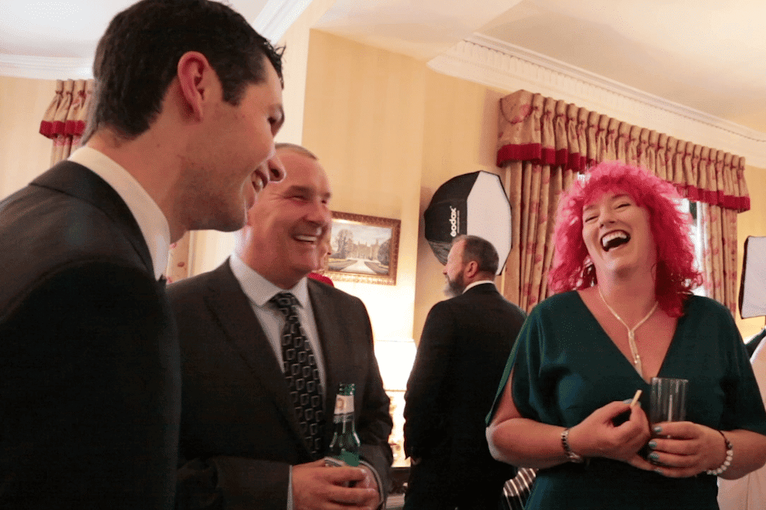 guests laughing at close up wedding magician at Manchester wedding