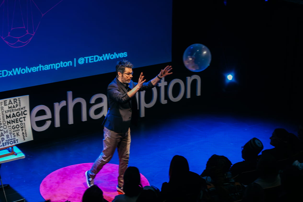 stage magician ed sumner with his unique act on stage at an event