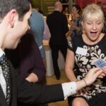 corporate events magician performing close up magic at a corporate event