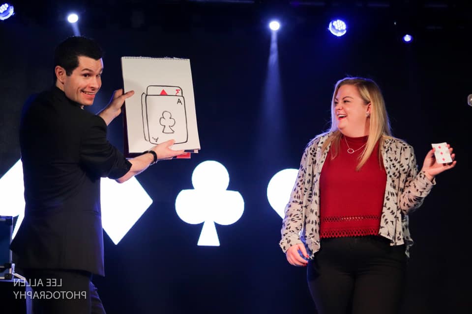 stage magician interacting with an audience member