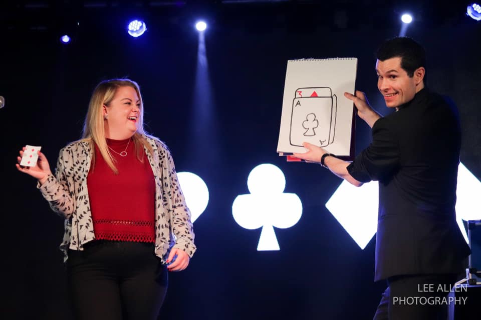 magician performing a stage magic show on stage in a theatre