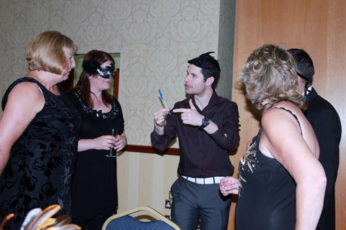 masquerade ball themed night magician performing to guests
