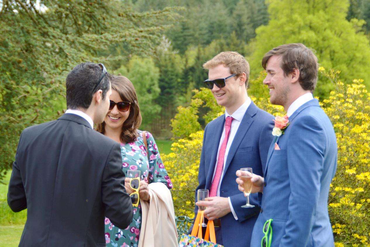 wedding magician performing for guests outdoors at ringwood hall, chesterfield