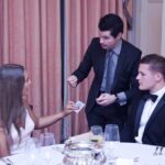 magician entertaining in a private dining room at a dinner party
