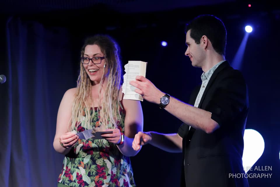 magician performing mind reading on stage at an arts festival