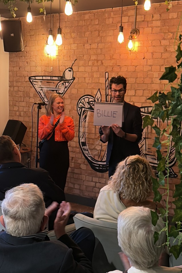 stand up magician getting applause at a magic night evening