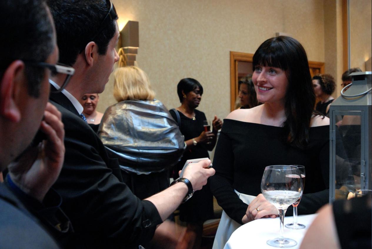 close up magician performing sleight of hand magic at a corporate event in london