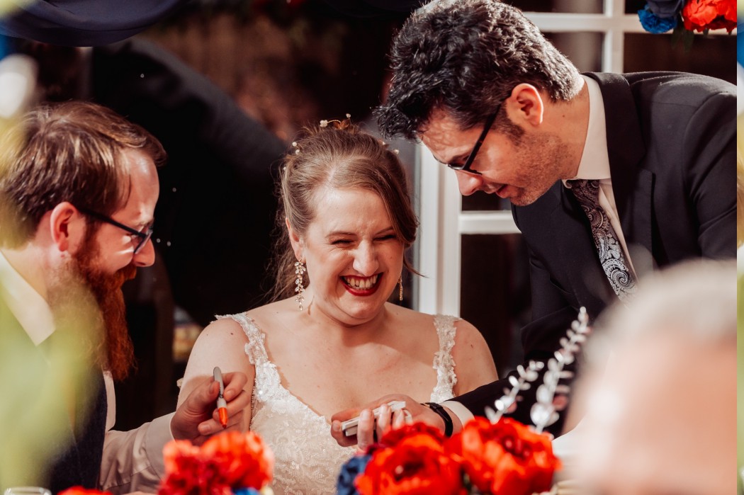 bride and groom a wedding being enertained by close up magic by wedding magician